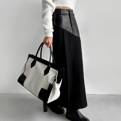 Falda de mujer estilo retro con costuras de piel sintética y largo medio, cintura alta y abertura en la cadera.