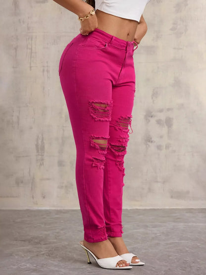 Vaqueros ajustados de cintura alta con efecto desgastado color fucsia